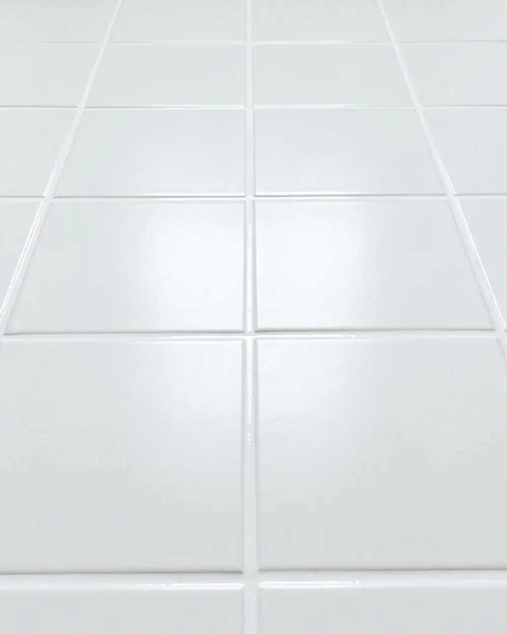 The same white floor tiles with clean, evenly filled white joints
