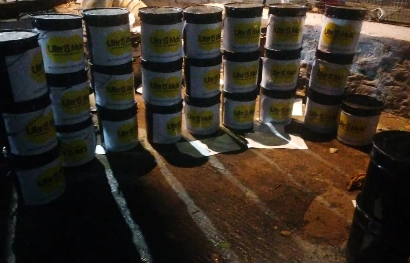 Rows of Ultra Max own-branded material drums stacked on a Bengaluru site